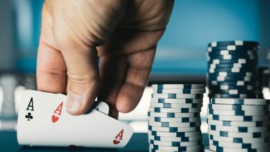 hold em texas poker tournament at casino a man is holding two ace cards