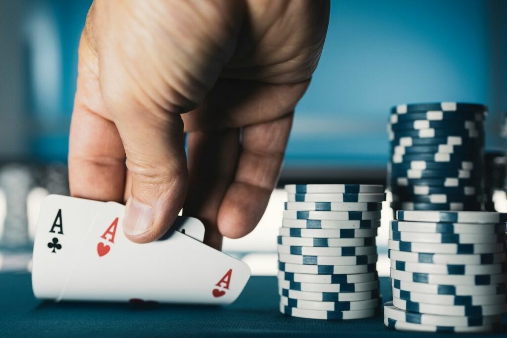 hold em texas poker tournament at casino a man is holding two ace cards